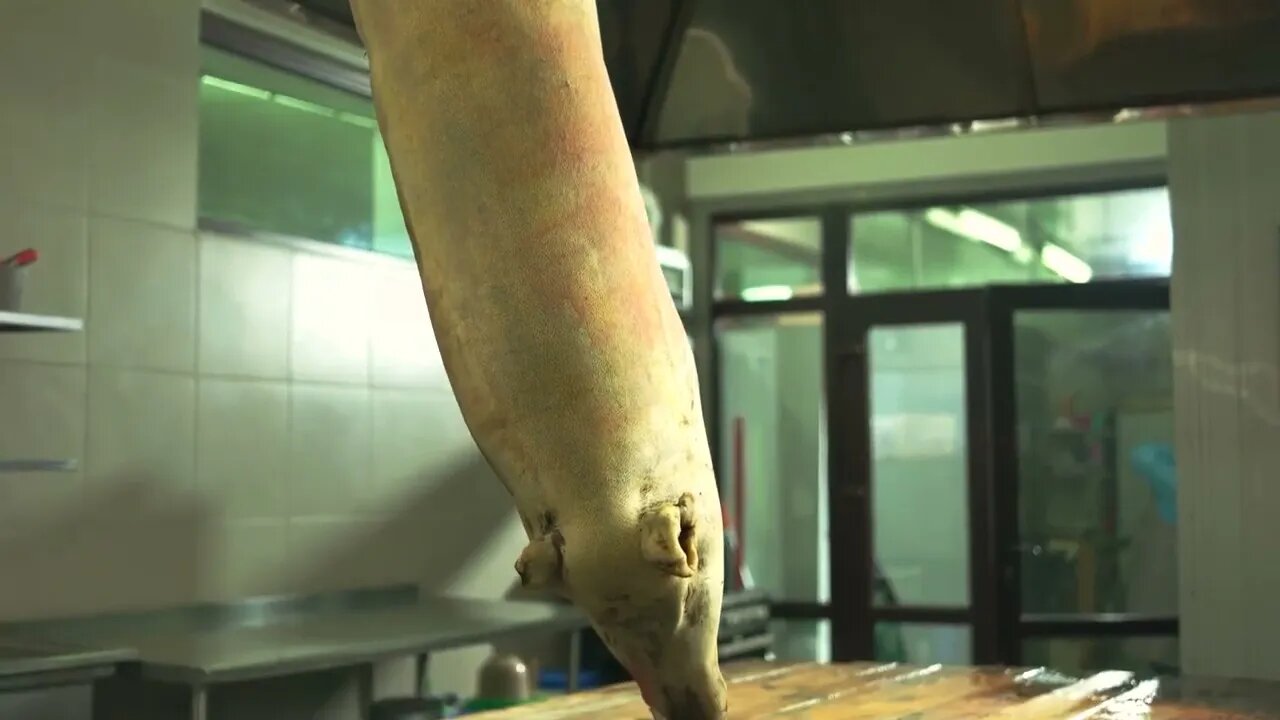 Pork hanging on hook at slaughterhouse Freshly slaughtered swine at butchery Healthy meat industry