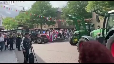 Dutch and German farmers meet at the border to exchange flags in an act of solidarity