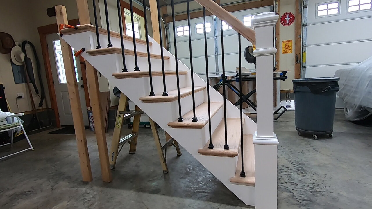 Installing a newel post, pickets, and handrail.