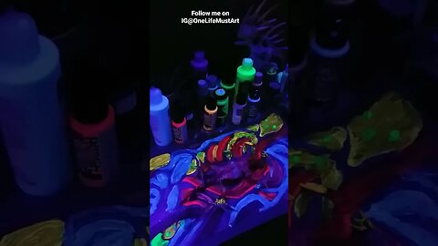 UV light. Black light masking tape diplocaulus painted and glows in the light.