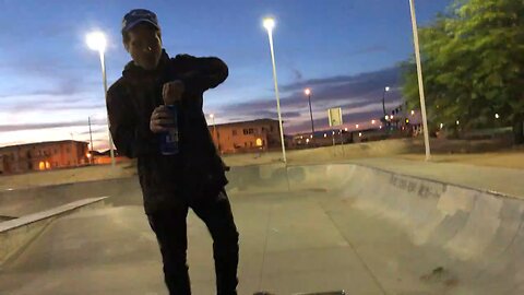 A SKATEBOARD AND TALL BOY