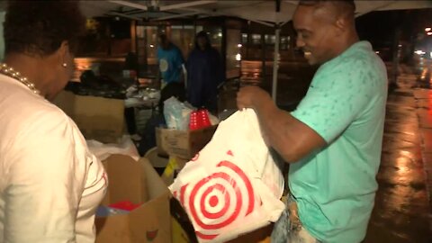 Community leaders post up in front of Pete's Supermarket to collect school supply donations