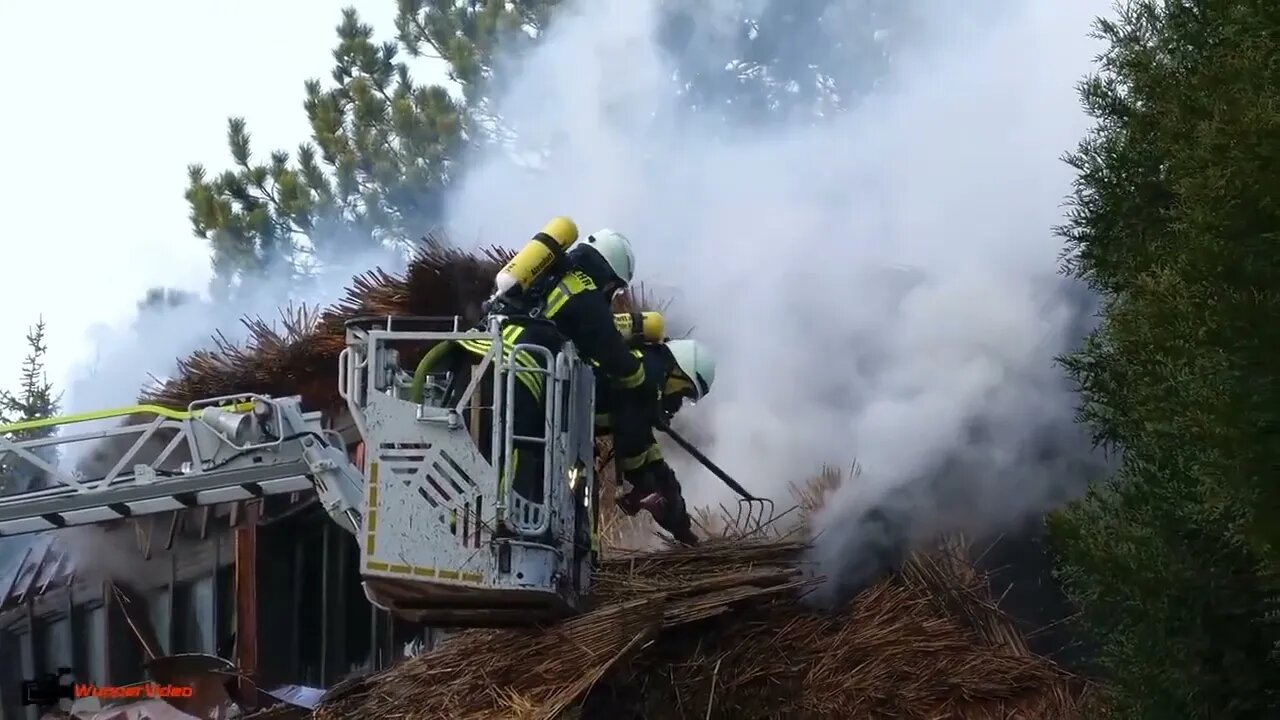 28. Smoke billows from thatched cottage fire