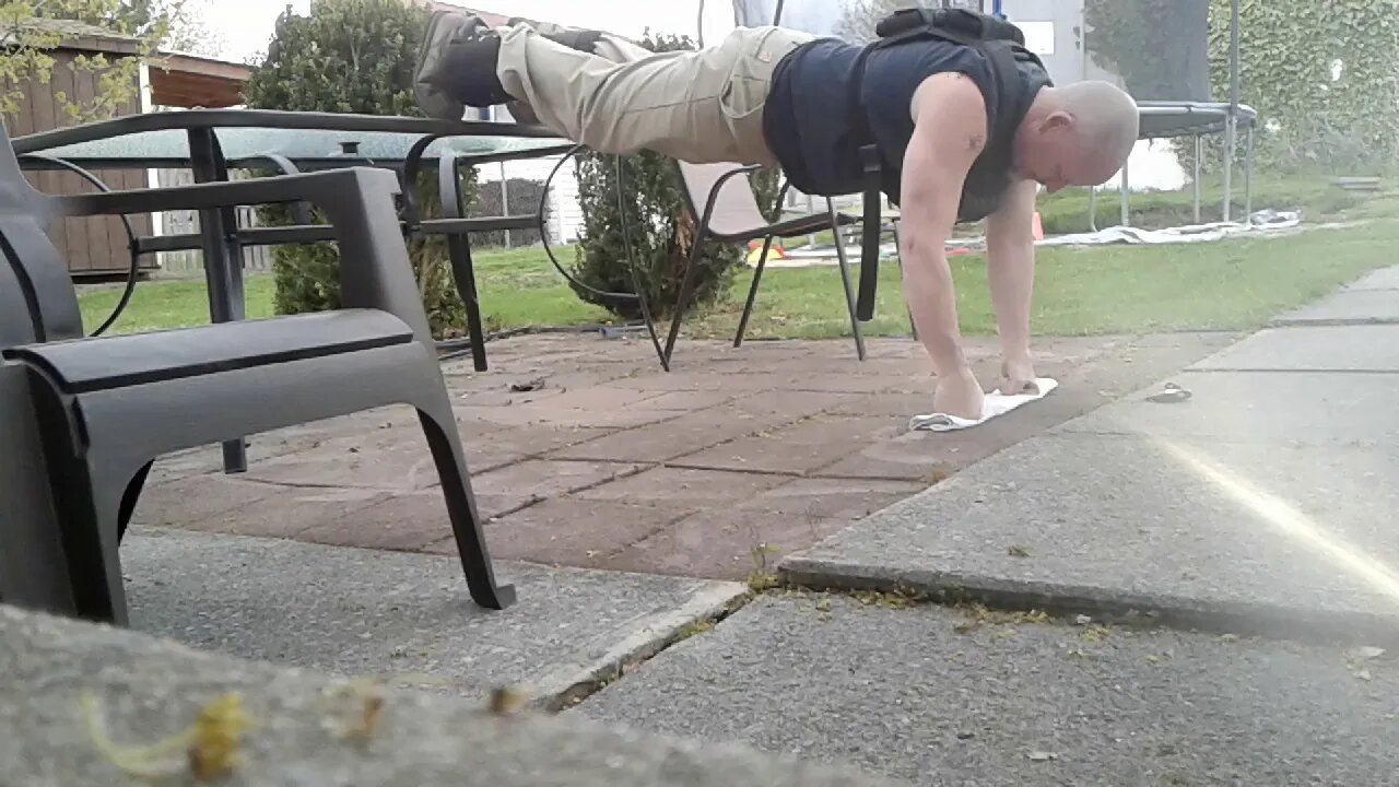 Weighted Isometric Hold Pushup Plank On Knuckles.