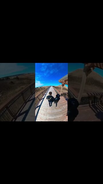 Walking by large sand dunes on the beach