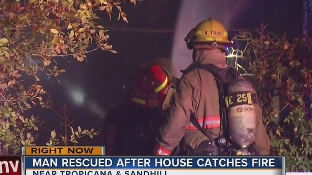 Man rescued in overnight house fire.