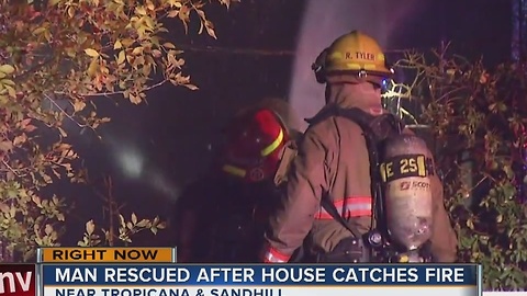 Man rescued in overnight house fire.