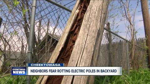 Neighbors fear rotting electric poles in backyard