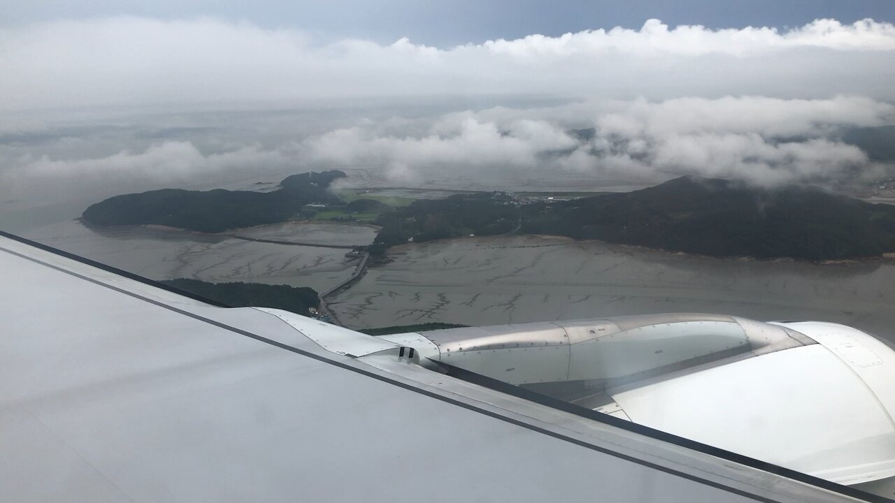 Flying over farmland in Korea and landing