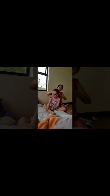 Sweet gramma is combing the hairs of her grandaughter-baby Abi 2017 Philippines