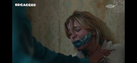 The bandit tied the cute mouth of the Russian beauty with gray tape