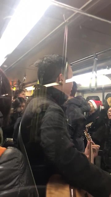 Skytrain transit commuters burst in Christmas caroling