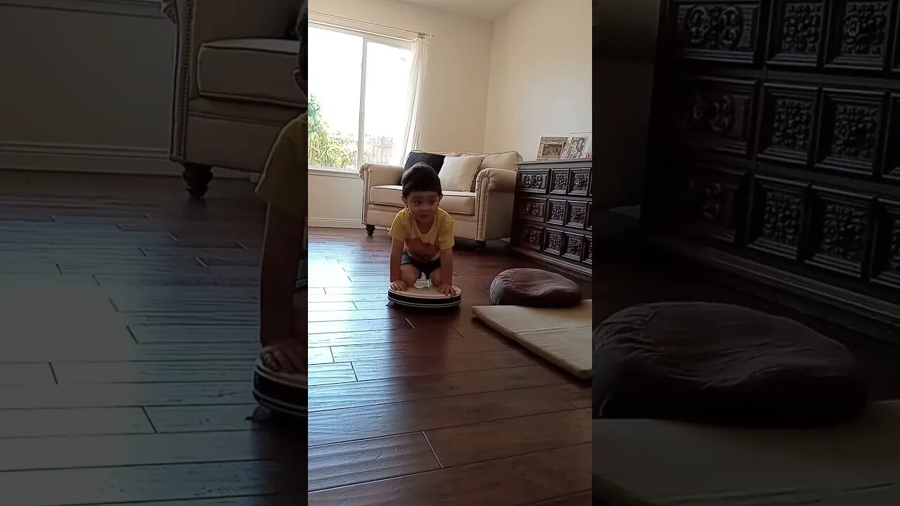 Little Boy Rides a Roomba Vacuum