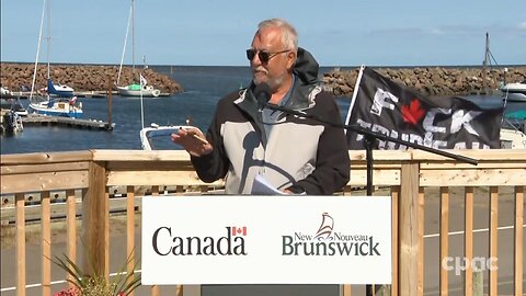 Liberal press conference embarrassingly captures man waving a "F*CK TRUDEAU" flag in the background