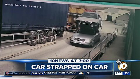 Man drives with car strapped onto car's roof?