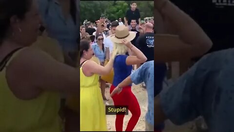A tourist was booed, doused with water and reportedly detained by police after climbing to the