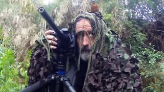 Pássaro pousa na cabeça de fotógrafo camuflado!