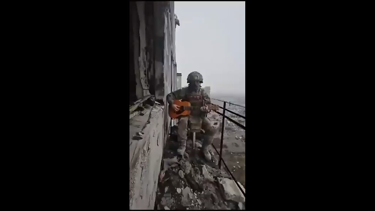 The Russian soldier drops his gun and grabs a guitar