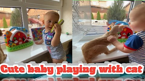 Cute baby playing with cat
