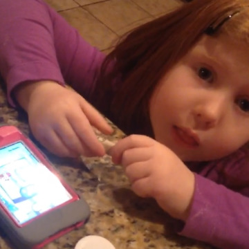Little Girl Tries to Put Money in a Cell Phone