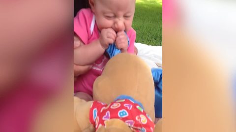 Baby Girl Bites On Her Puppy Toy
