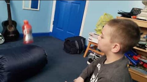 Kid gets overexcited after doing bottle flip