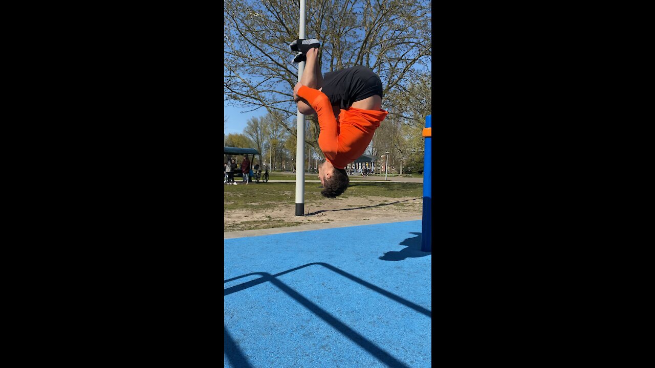 Athletic guy doing backflip in the park
