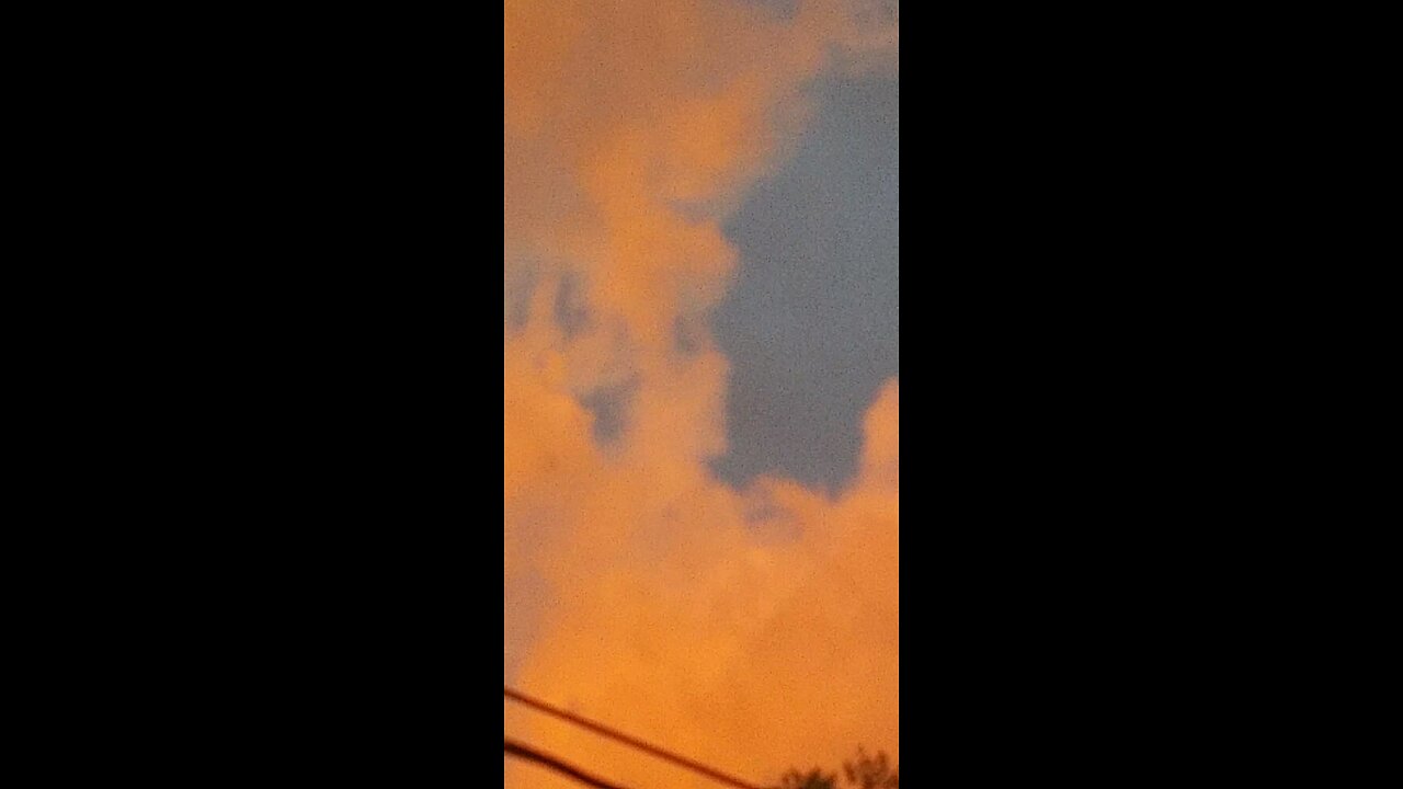 π£π³ππStrange orange pink clouds floating east over π£π³ππ