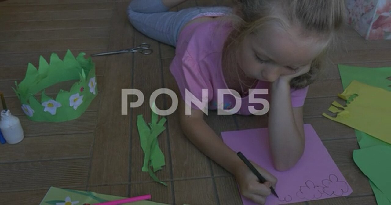 https://www.pond5.com/stock-footage/item/52359711-little-girl-pink-t-shirt-blonde-braid-lying-floor-dwanig