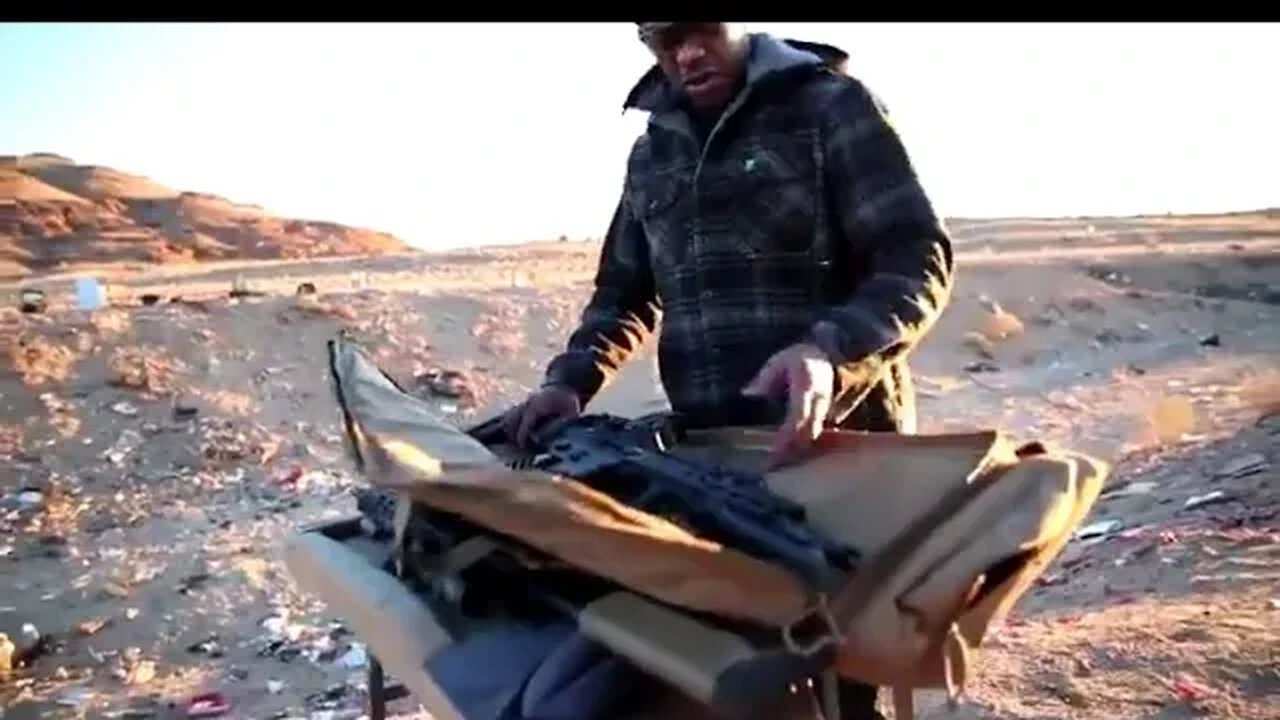 Jon Jones firing assault rifle and pistol in the desert target practice