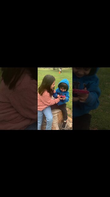 Baby girl and her baby brother chill in the park on a cut trunk of a tree-taking a funny pic