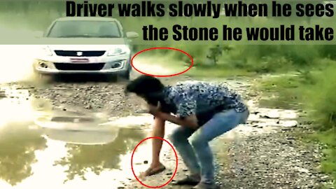 Driver Walks Slowly When He Sees The Stone He Would Take.