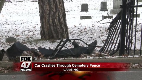 Car damages fence at Mount Hope Cemetery