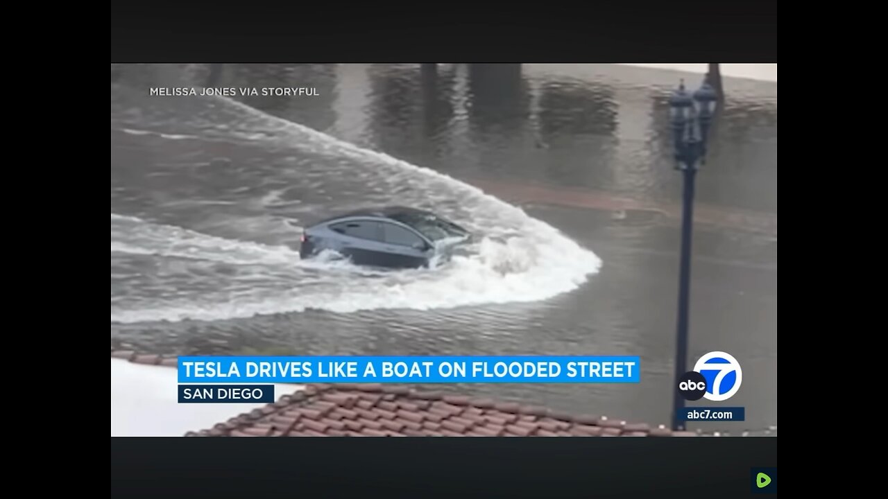 Tesla plows through flooded street