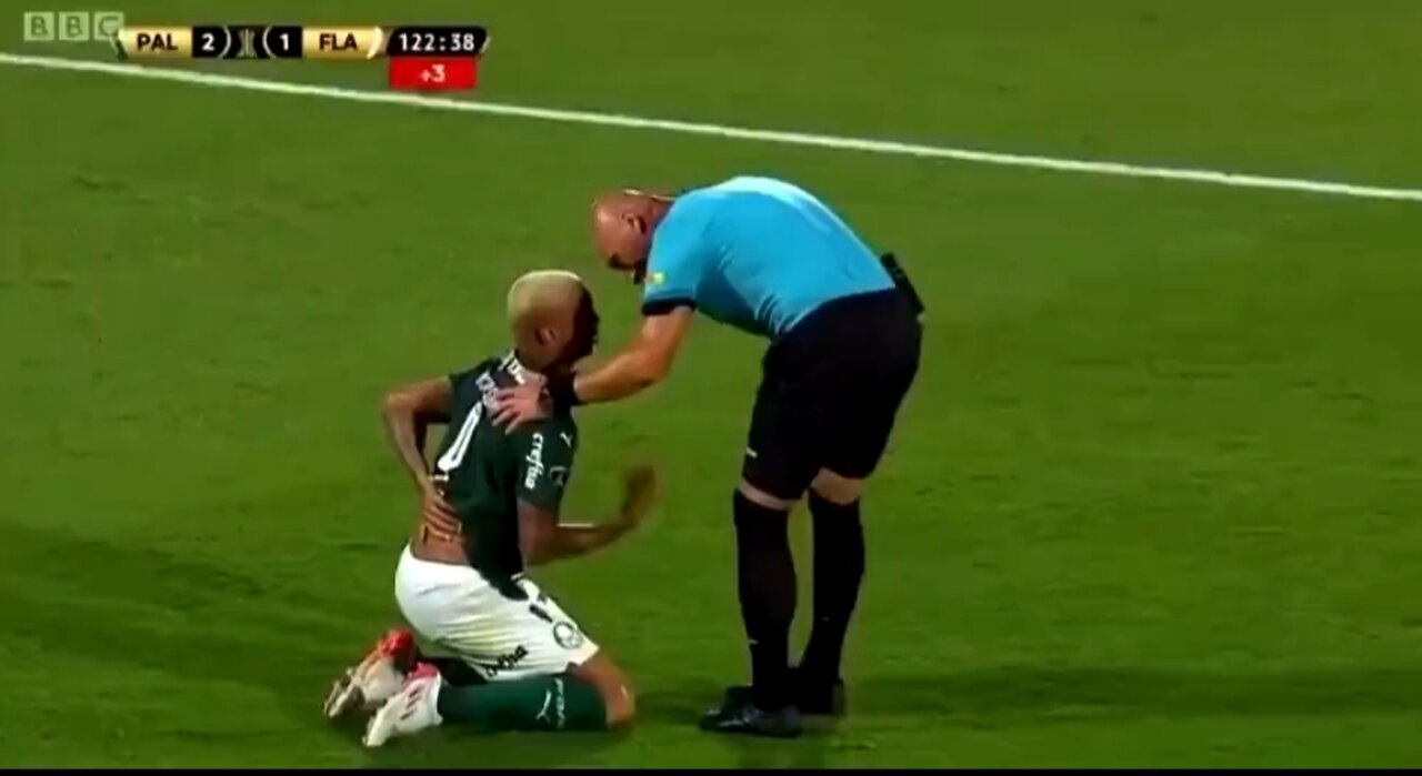 Brazilian player falls to the ground after touch from referee