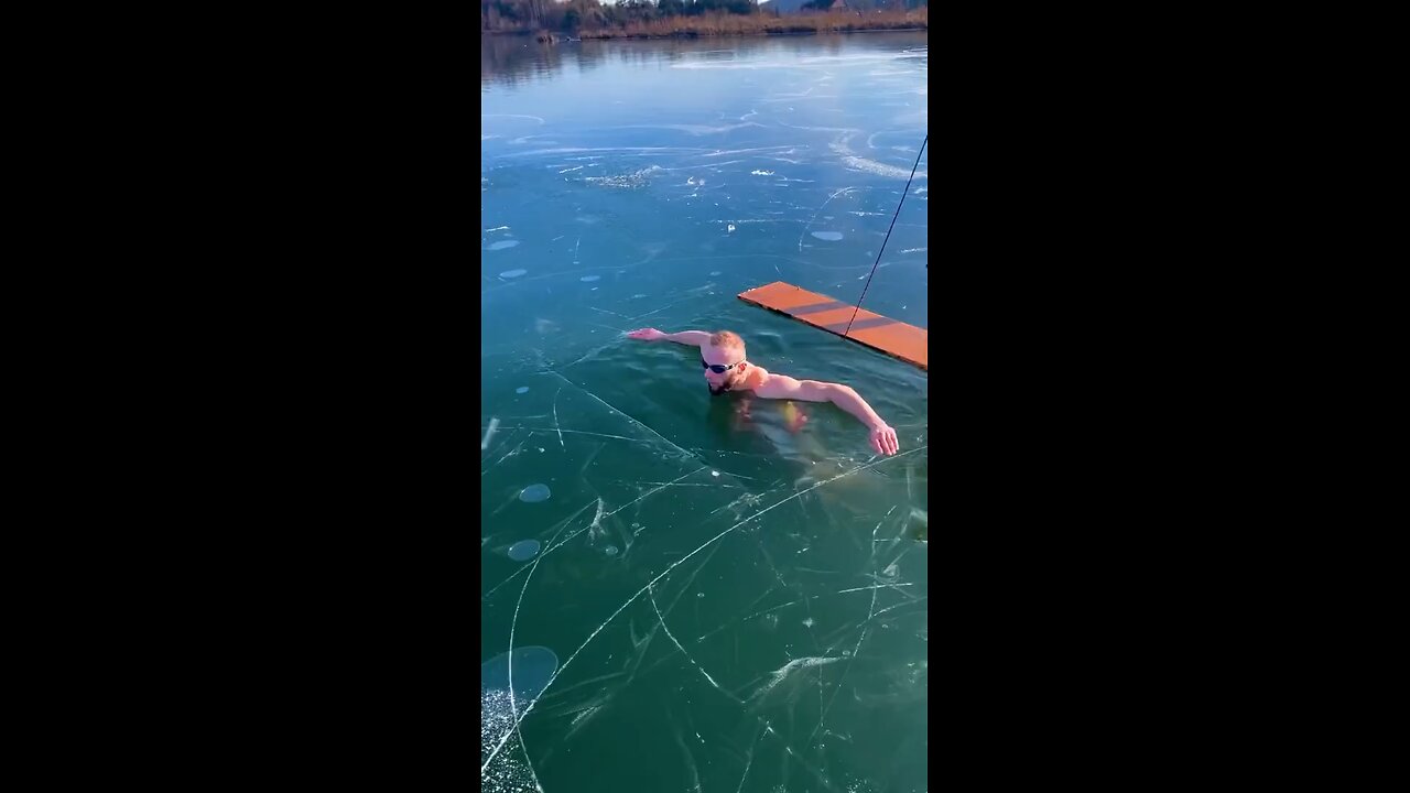 Ice swimmer panics under frozen lake in chilling video