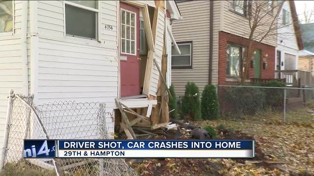 Car crashes into house after driver is shot