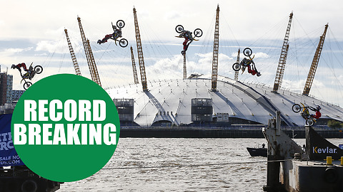 Travis Pastrana performs the first motorcycle backflip between two barges