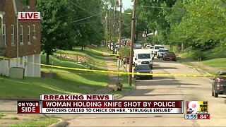 Woman holding knife shot by police, hospitalized