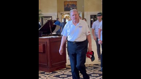 Trump flaunts his new slick back hairstyle while golfing.