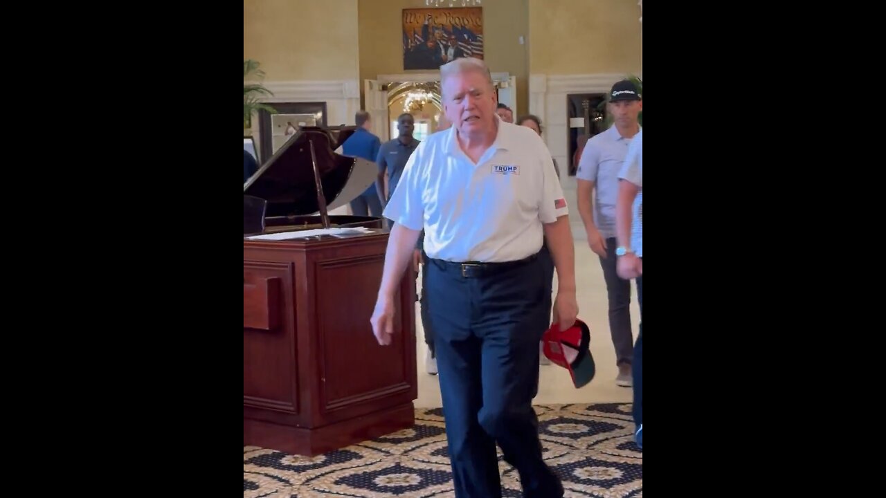 Trump flaunts his new slick back hairstyle while golfing.