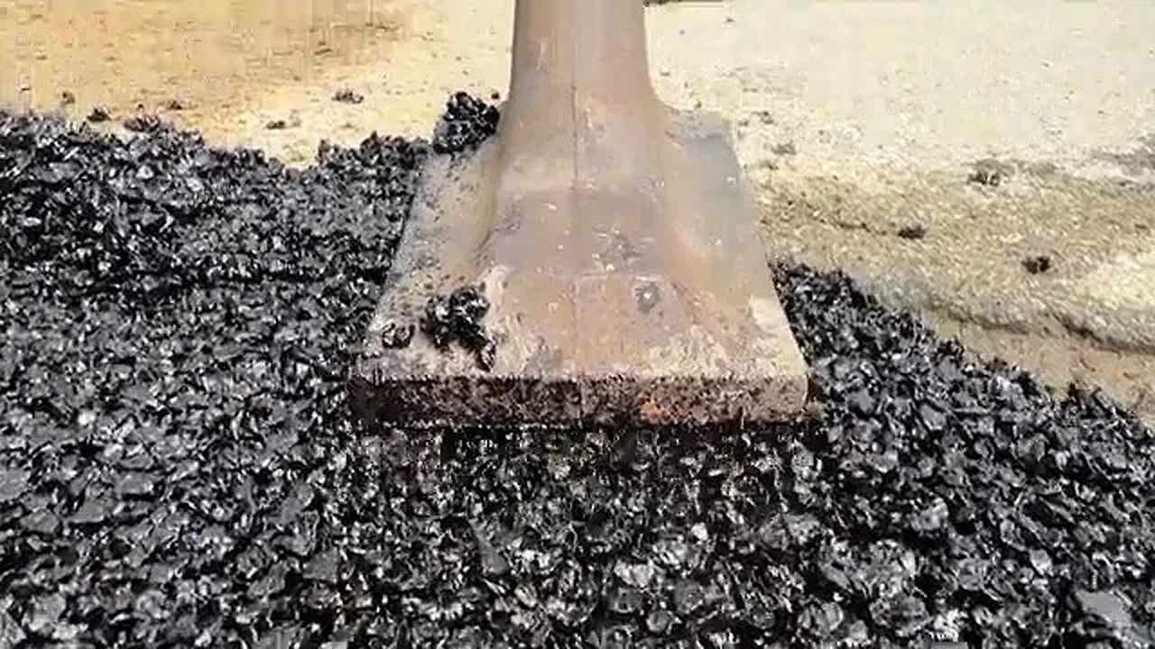 Here's Arnold Schwarzenegger filling a pothole on a Brentwood street.