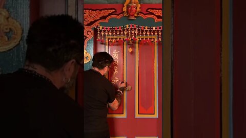 Painting Om Mani Padme Hum on the door to the studio