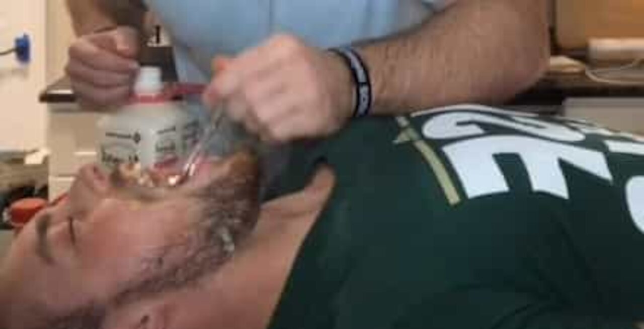 Guy uses brother's mouth as cereal bowl