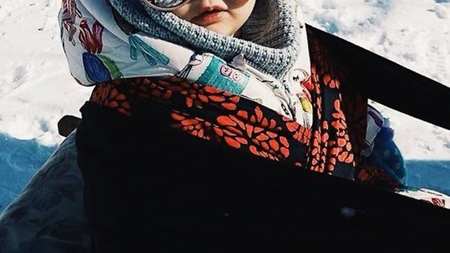 Tired baby sleeps right through sled ride