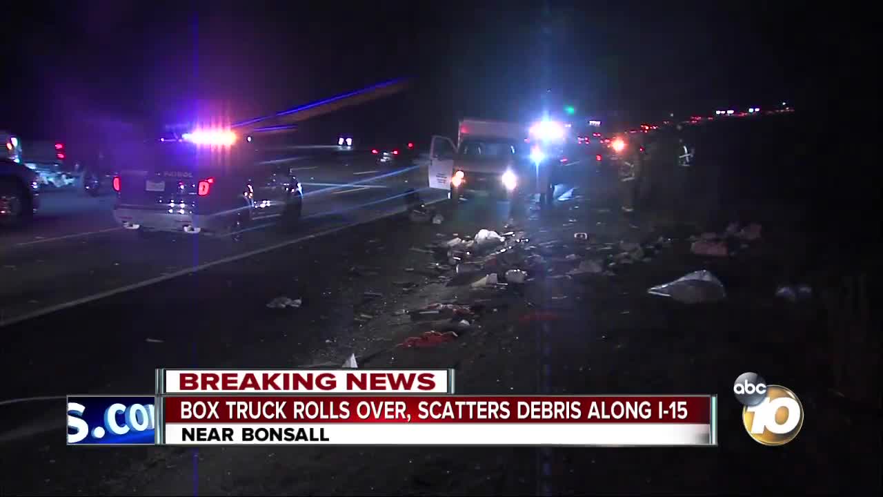 Box truck rolls over, scatters debris along I-15