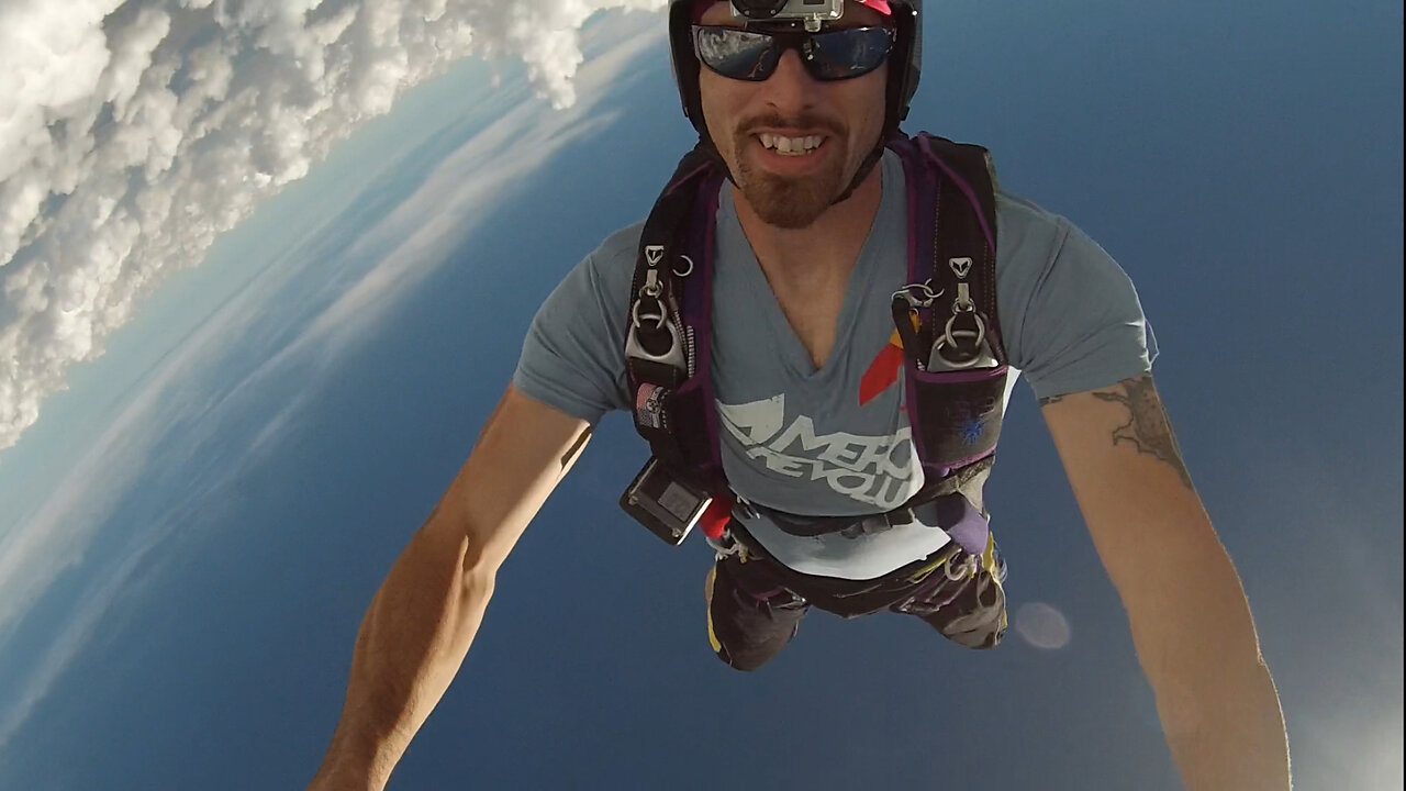 Skydiving along the edge of big puffy clouds