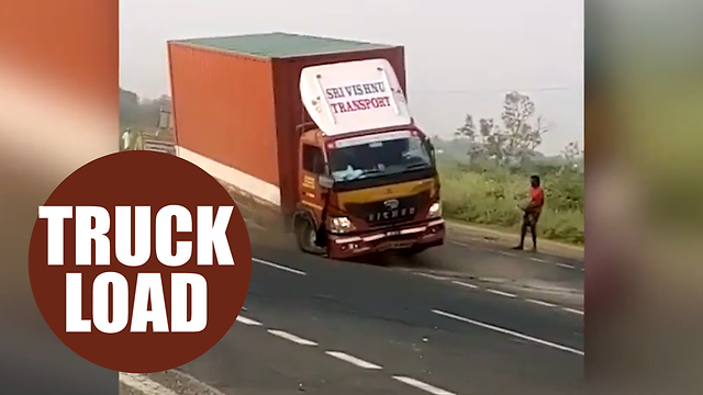 A driver was almost run over by his own truck - after it got stuck in reverse on the motorway.
