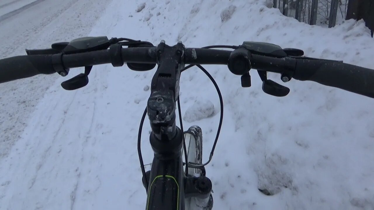 Winter: Cycling snowy Finnish streets from bridge to bridge under snowing 3.1.2022