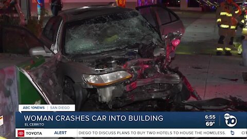 Woman taken to hospital after car crashes into building